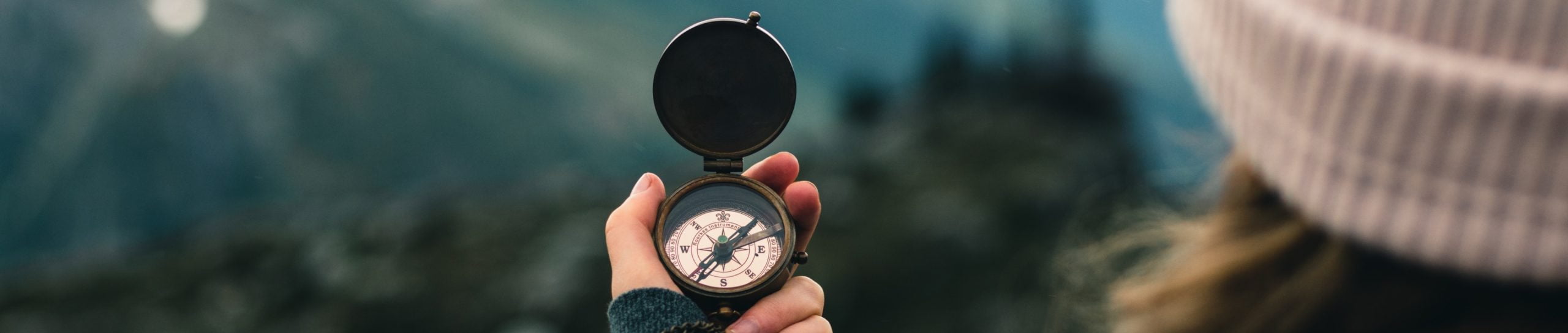 A person holding up a compass