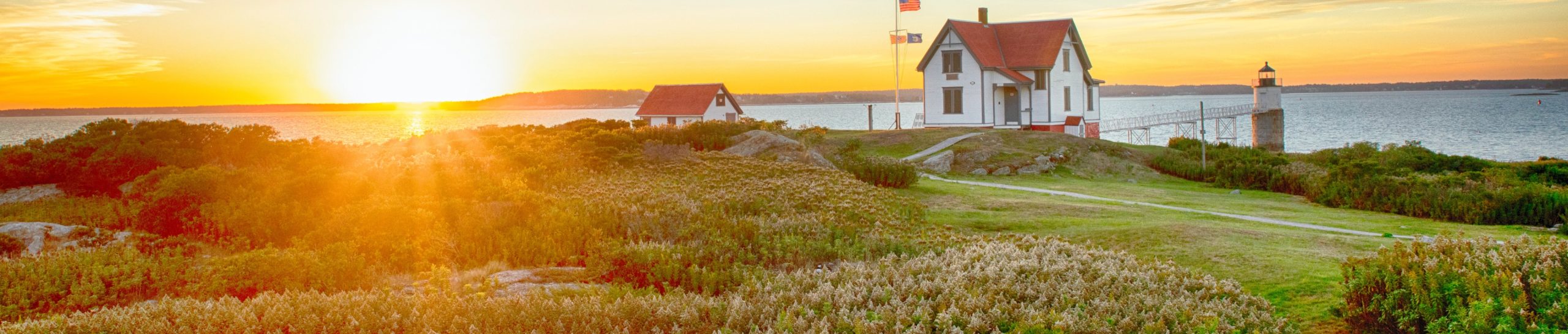 A sunset over a house on the water